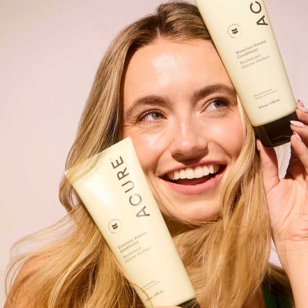 Acure volumizing volume conditioner tube on a beige background